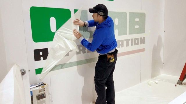 Sign maker using a low tack paper transfer tape to transfer large cut vinyl lettering